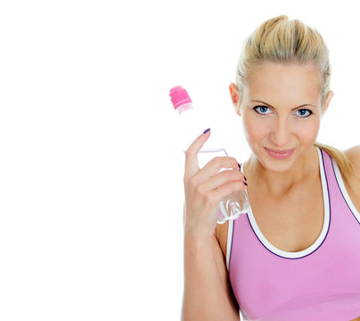 Pretty young female fitness trainer with bottle of water.