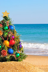 Christmas tree on the sand in the beach