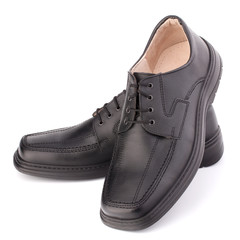 Black glossy man’s shoes with shoelaces