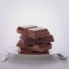 Chocolate bars stack on plate.