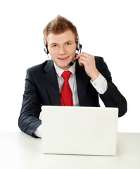 A portrait of a young man working on a laptop