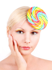 portrait of blonde young girl with lollipop, fashion makeup