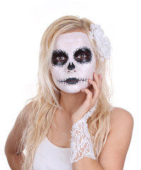 skull makeup on young girl with white roses and lace gloves