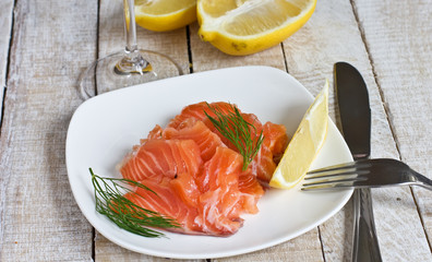 Salmon on plate with lemon and dill