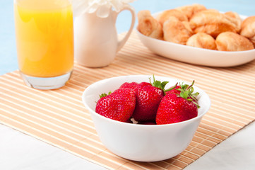 Breakfast with berries,orange juice and croissant