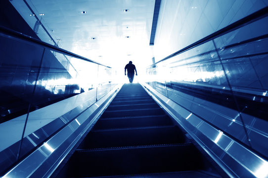 man on the escalator, modern interior..