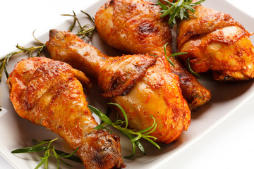 Grilled chicken legs on white background