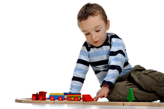 Boy playing with a train set 