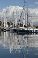 Fotobehang reflection of Yachts moored in a marina © William Richardson