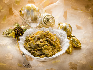 spaghetti carbonara with artichoke on christmas table