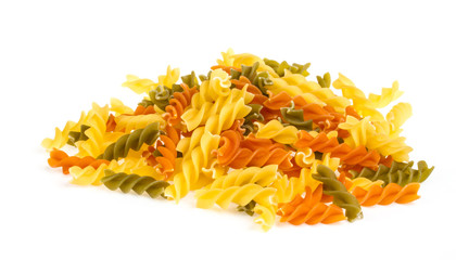 Uncooked pasta fusilli in different colours, white background