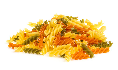 Fototapeta premium Uncooked pasta fusilli in different colours, white background