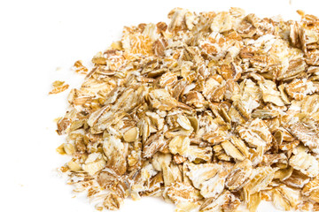 Heap of dry rolled oats isolated on white background