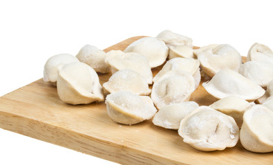 Some raw dumplings on the wooden board