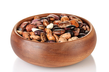 Wooden bowl with beans isolated on white
