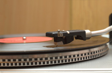Turntable  and vinyl record with red label closeup
