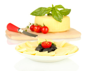 sliced mozzarella cheese with vegetables in the plate isolated