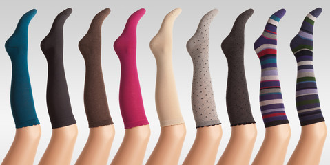 woman socks on plastic legs against grey gradient background