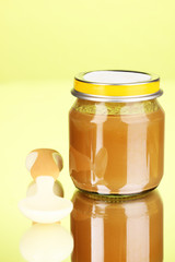 Useful and tasty baby food with beige small spoon