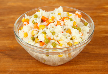 Risotto in bowl on wooden background