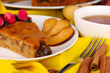 Tasty pie on plate on wooden table