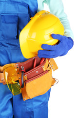 Male builder in blue overalls with yellow helmet  isolated