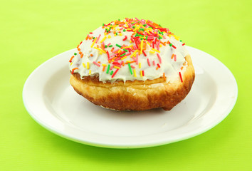 Tasty donuts on color plate on color background