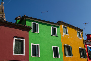 The row of colorful houses in Burano street, Italy.