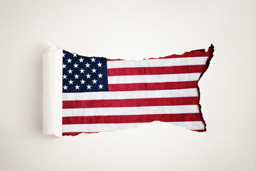Torn paper reveals the American flag