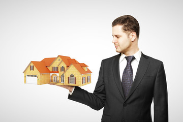 man holding house