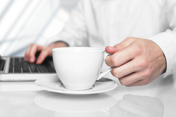 laptop and white cup