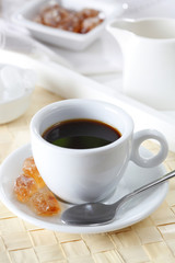 Coffee with spoon and brown sugar