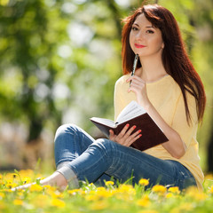 Pensive woman in the park with flowers © Dmytro Sunagatov