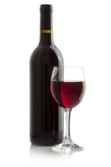 Elegant red wine glass and a wine bottle isolated on a white
