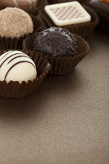 Assorted gourmet chocolate bonbons in paper cups.