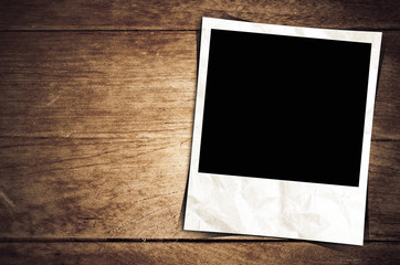 Old photo frame on wood background