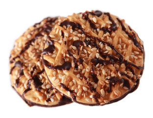 Two cookies with sesame seeds and chocolate in over white