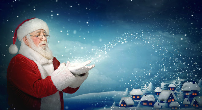 Santa Claus blowing snow to little town