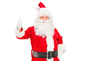 A happy Santa claus standing and giving a thumb up
