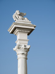 Fototapeta na wymiar Starożytna skrzydlaty posąg lwa na starej kolumnie
