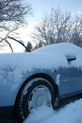 Winter car covered with fresh snow