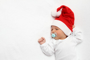A beautiful baby with Santa Claus hat