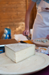Italian cheese at local market with vendor in the background