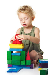 Little girl playing with wooden blocks