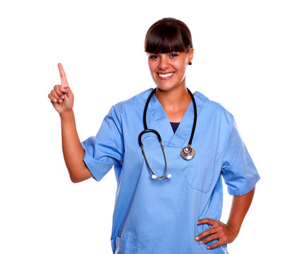 Charming Young Nurse Looking At You Pointing Up