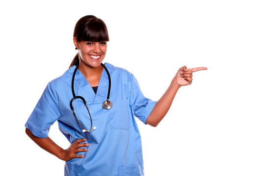 Smiling Young Nurse Looking At You Pointing Left