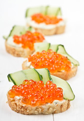 Sandwiches with red caviar and cream cheese