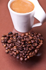 cup of coffee on a background coffee beans heart