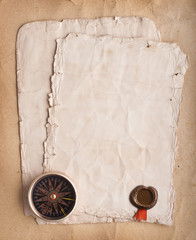 old compass on grunge background with a wax seal and ribbon