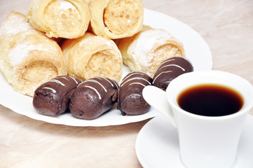 Puff pastry rolls with cream, chocolate and coffee potatoes